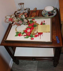 lot 13 image: Side table - 25x25x22 and contents (embroidered strawberry basket framed art and more)
