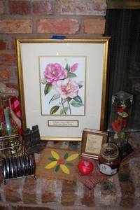 lot 65 image: Home dcor Rose artwork print, glassed in rose music box, candle, coaster holder cast iron copper color bookend with Notre Dame Cathedral design and more