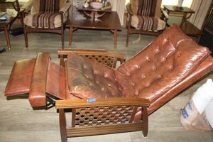 lot 95 image: Vintage brown upholstered recliner. Features a wooden fence design on sides.