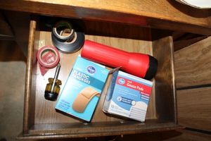 lot 107 image: Desk items Flashlight, tape, twine, light timers, extension cords and glue