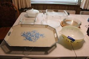 lot 102 image: Pyrex baking dishes, bowl, pie plates, and serving racks