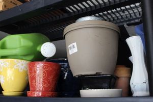 lot 66 image: Planters, Mostly Ceramic, Vases and Plastic watering Can and a couple Plastic Pots