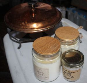 lot 42 image: Three Aromatic Candles and a Copper Pot with Lid and Stand
