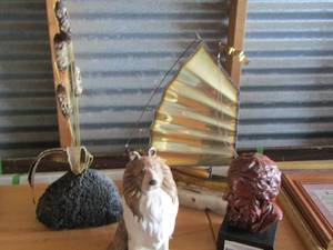 lot 103 image: metal sailboat sitting on a piece of stone dcor- man statue and a dog figurine