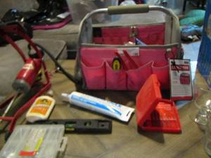 lot 196 image: Pink Craftsman tool caddy with various small hand tools, plumbers caulk, bell air pump