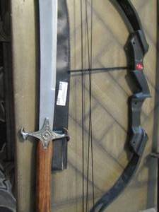 lot 327 image: Brown handled sword  SCIMITAR  full length 39  blade 25 length with SHEATH  and a    COMPOUND BOW