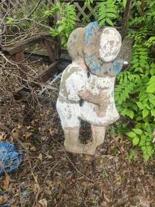 lot 215 image: Concrete boy and girl yard art - missing piece on girls foot