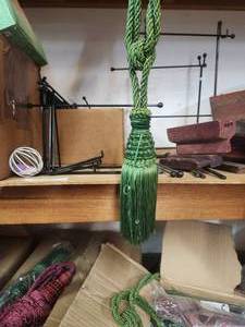 lot 250 image: Box of green tasseled curtain tiebacks and some maroon