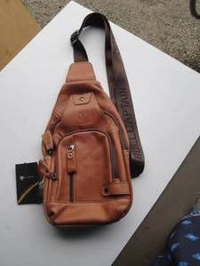 lot 35 image: BULLCAPTAIN Leather Backpack  Casual Crossbody Bag  Purse With Tags. Has Multi Pockets And USB Port, About 13 x 7