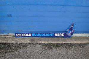 lot 239 image: Tin Bud Light Sign... Ice Cold BuuudLight Here About 53-L x 5-H.  15-H.  At Bottle