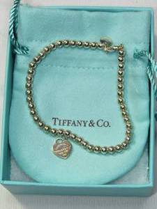 lot 275 image: Tiffany & Co. .925 Silver charm bracelet in original box