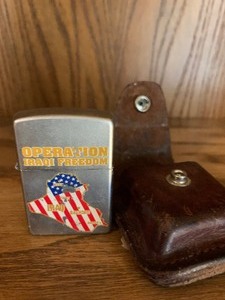 lot 15 image: Zippo Operations Iraq Freedom with leather pouch