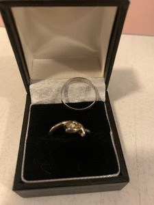 lot 35 image: White gold wedding band and diamond ring