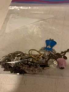 lot 134 image: Small portion of costume jewelry in baggie