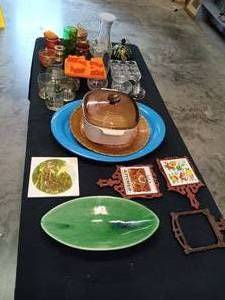 lot 101 image: Table Full Including Platters, Ceramic Tiles, Vintage Vaseline Glass, Anchor Hocking and Much More