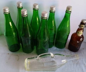 lot 131 image: 7 Green Decor Bottles, A Clear Glass Decanter and A Grolsch Lager Beer Bottle