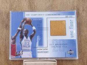 lot 129 image: Michael Jordan - 2001 Upper Deck basketball card - Ovation UNC piece of game used floor card - #MJF3