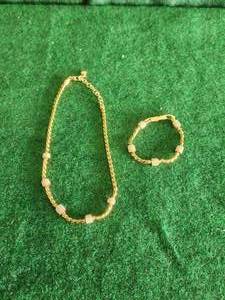 lot 26 image: Gold necklace and bracelet set by Brighton