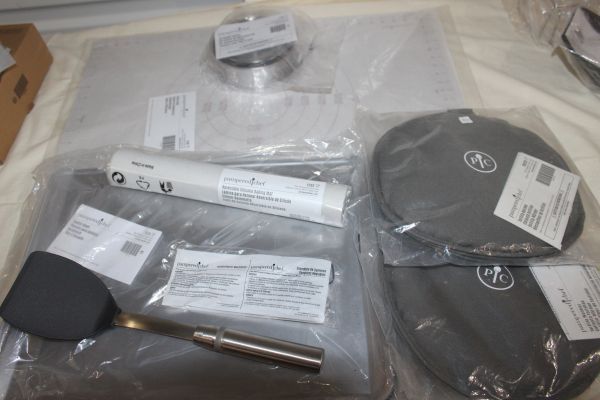lot 8 image: Unused Pampered Chef Items Tortilla Warmers (2), Reversible Silicone Baking Mat, Adjustable Measuring spoon Set, Spactula, Cookie Sheets (3), Pie Dough Cutters, Pastry Mat,