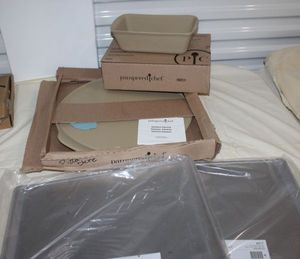 lot 52 image: Unused Pampered Chef Items Classic Pizza Stone and Classic Stone Loaf Pan and 2 Cookie Sheets