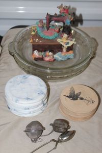 lot 92 image: Pie Plates, Coaster Sets, Tea Strainers and Decroative Sewing Music Box