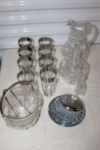 lot 106 image: Silver Ringed Glasses, Ice Bucket, Relish Dish with Lid and Star of David Bell and vase, Beautiful Ruffle Edged etched Pitcher, This does have a small crack by the handle