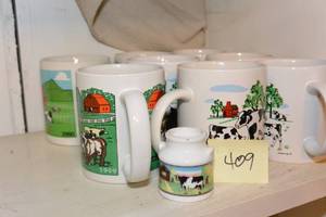 lot 409 image: SET OF VARIOUS COW MUGS AND A TINY MILK JUG
