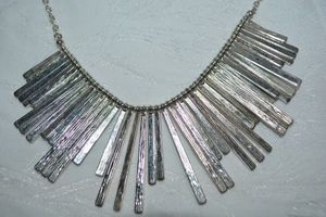 lot 2 image: Signed Liz Claiborne (1976 - ) modernist textured staggered length spindle metal necklace. Has LC hang tag. 18L