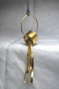 lot 8 image: Abstract person pendant with circle head, long legged body and twisted arms 5L pendant on a 26 cord necklace.