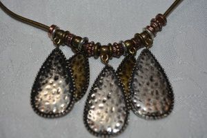 lot 32 image: Tri colored hammered tear drop shape pendant dangle corded necklace. Lobster clasp. 18L with 2 extension