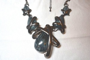 lot 38 image: Shiny black metal encased ceramic fire glazed tear drop stations on black cable chain necklace. Lobster clasp. Space age neutron star vibe. 14L with 3 extender.