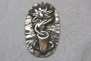 lot 42 image: Signed polished pewter Goddess Charms by Deva Designs pocket worry stoneSelf Love with Goddess image on one side and Own Drummer on reverse. You move to your own drumbeat and Her Eternal Strength reference. 1960s style.