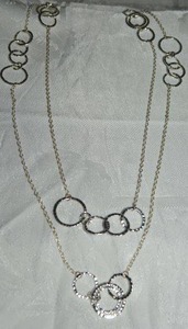 lot 56 image: Modernist continuous open hammered disc station necklace. 58L