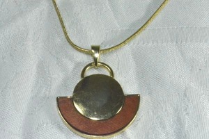lot 200 image: Modernist gold finish snake necklace with half moon pendant decorated with red wood. 30L with 2 extender. Pendant 1.5L. Lobster clasp.