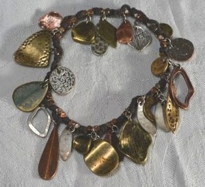 lot 64 image: Bohemian tri colored hammered dangle stretch bracelet.