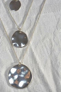 lot 66 image: Set of 3 graduated size polished disc pendant necklaces. Designed to be work together as a set or separately. 26L, 20L, 16L with lobster clasps.