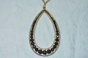 lot 71 image: Modernist open tear drop faceted crystal accented pendant on 24L gold tone cable chain necklace. Lobster clasp. Pendant 3L