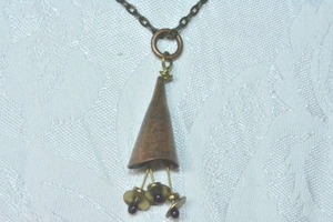 lot 74 image: Copper Color cone shaped pendant on antiqued cable chain necklace. 30L with lobster claw clasp. Extra large ring pendant 2.25L