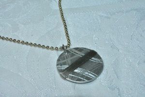 lot 78 image: Modernist bi color round disc wire wrapped pendant on 30L ball bead chain.