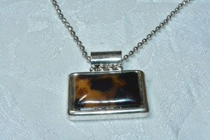 lot 80 image: Modern faux leopard front slide pendant on a 20L ball bead chain.