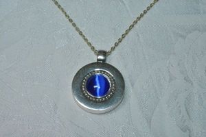 lot 82 image: Modern faux Cats Eye round disc pendant with large bale on 18L flat link cable chain necklace. Spring ring clasp. Pendant 1.75L