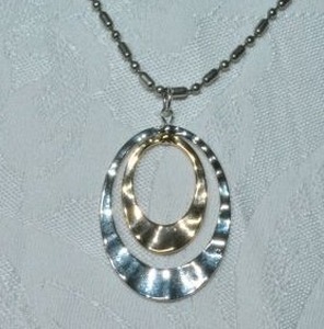 lot 90 image: Modernist articulated bi colored tear drop pendant on 24L silver tone ball bead necklace. Clasp marked USA