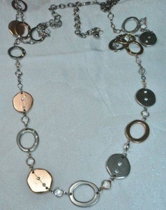 lot 99 image: Signed Chicos bi colored oval solid and negative space station necklace. 41L with 4 extender. Has Chicos hang tag. Lobster clasp.