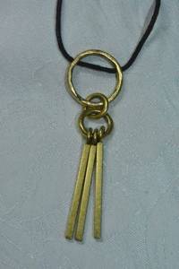 lot 107 image: Signed Madewell modernist gold tone spike pendant on corded necklace. Has M hang tag with crystal. 24L Decorative spring ring clasp.