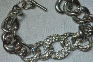 lot 115 image: Polished silver large link modernist bracelet with crystal accented center links. Toggle clasp. 8L