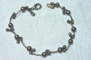 lot 128 image: Signed Premier Designs gunmetal curved bar and ball link bracelet. 7.5L. Lobster clasp with PD hang tag.