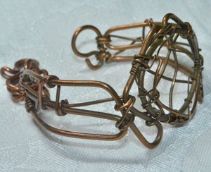 lot 132 image: Artisan crafted hand wrought copper wire cuff style bracelet with shepherd crook clasp.