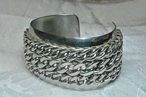 lot 134 image: Heavy industrial cuff bracelet with chain top. About 1.75W x 3L