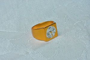 lot 147 image: Stamped aluminum rose gold color modernist ring with etched spirograph top. Size 7.5