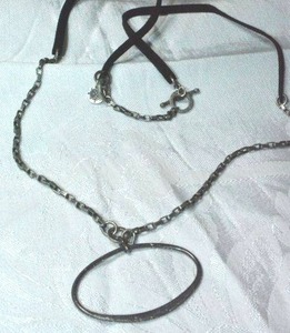 lot 148 image: Signed Rawhide and chain necklace with East-West oval modernist pendant and unknown hang tag. 34L with Toggle clasp.